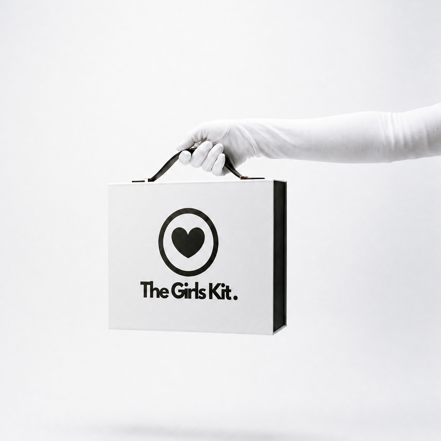 Hand holding a box labeled 'The Girls Kit' on a white background