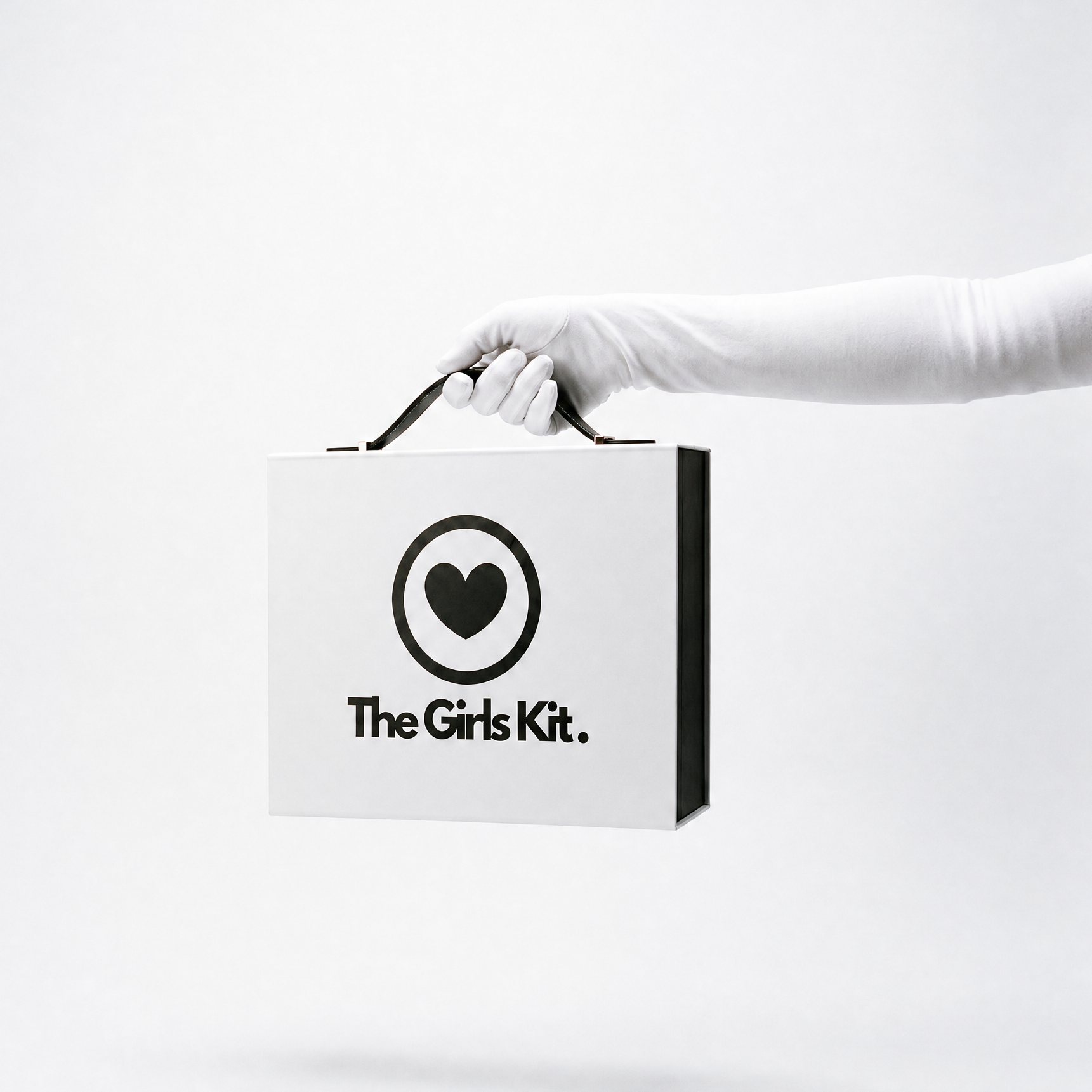 Hand holding a box labeled 'The Girls Kit' on a white background